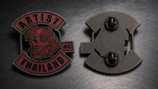 Macro view of a custom 2D motorcycle club pin showing raised metal and recessed enamel.