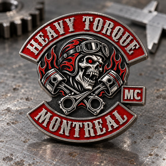 HEAVY TORQUE 3D metal motorcycle club pin with deeply sculpted crossed pistons and connecting rods on an engine builder bench.