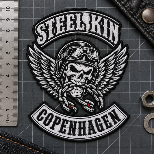 Fine woven chest patch with small legible neutral lettering for a motorcycle club, shown at precision inspection mat.