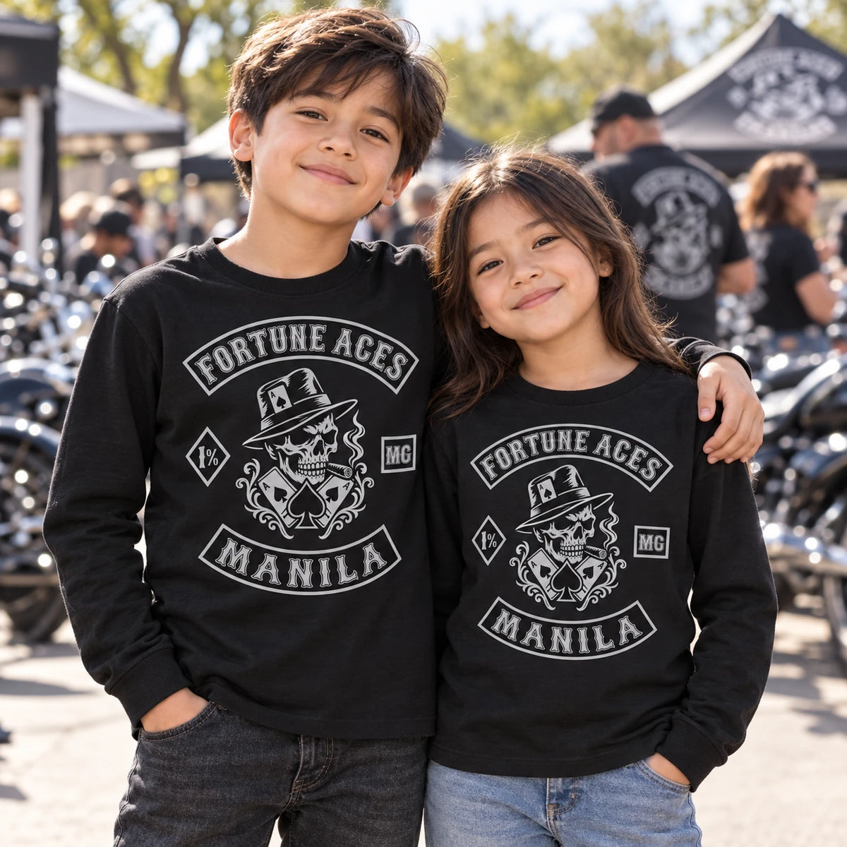 Boy and girl wearing youth-size motorcycle club long-sleeve shirts at a family event.